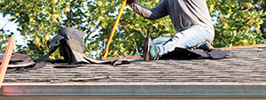 roofer taking off an old roof to replace it