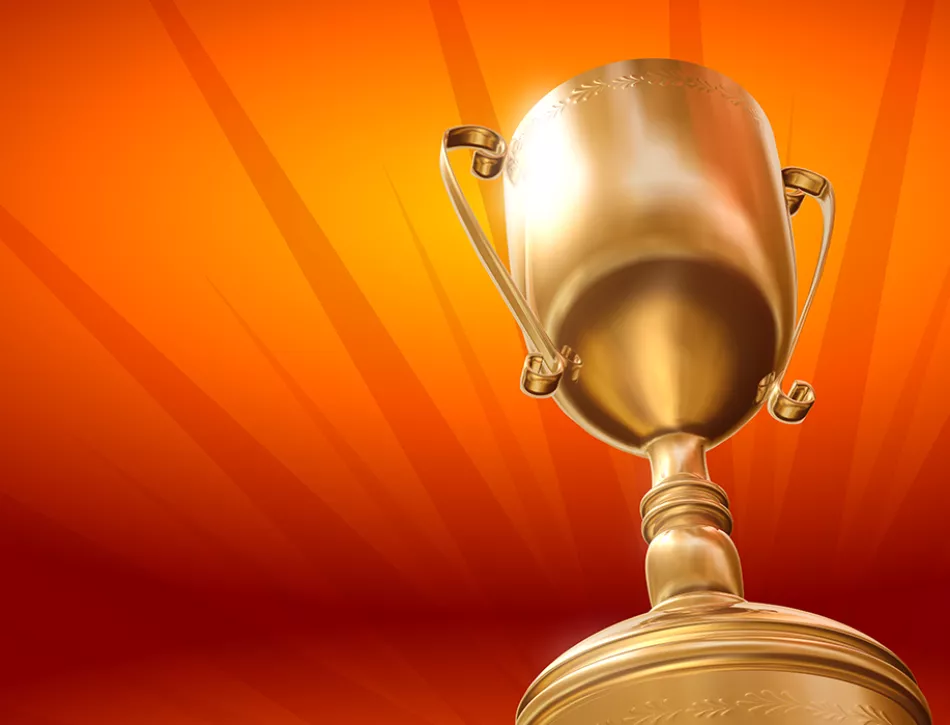 Gold award cup on an orange background